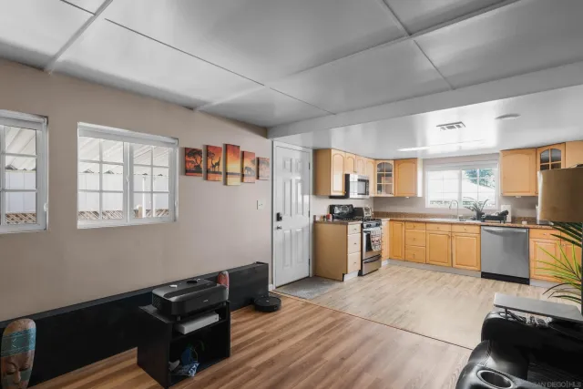 a living room with furniture and kitchen view