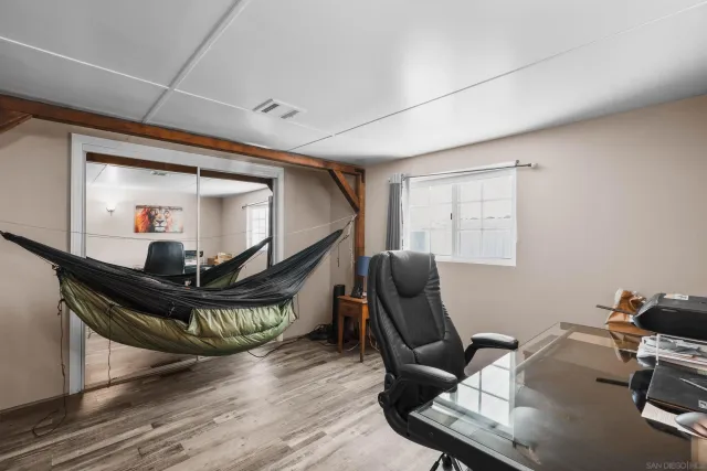 a view of a workspace with furniture and a window