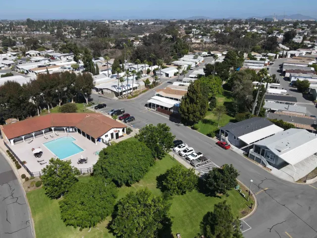 an aerial view of residential houses with outdoor space