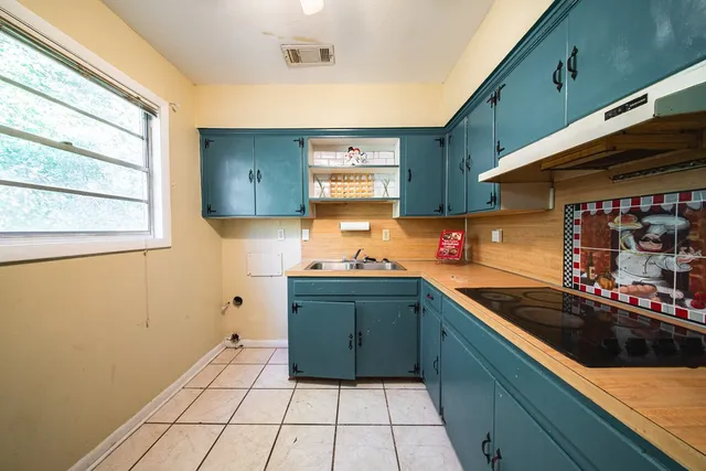 a kitchen with stainless steel appliances granite countertop a sink and cabinets