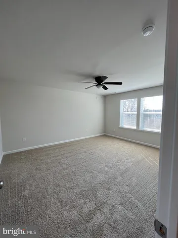 an empty room with windows and entrance