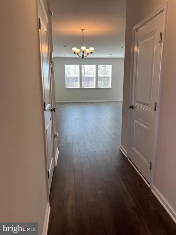 wooden floor in an empty room with a mirror