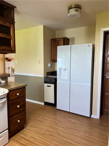 a kitchen with a refrigerator and a stove top oven