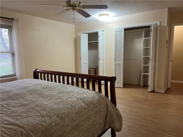 a living room with a fireplace and wooden floor