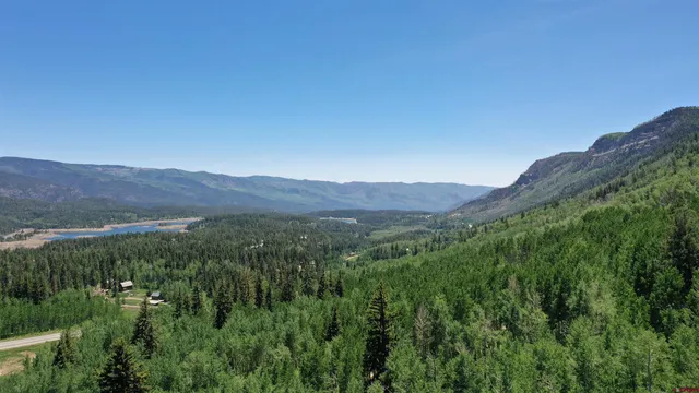 a view of a lush green hillside and a building