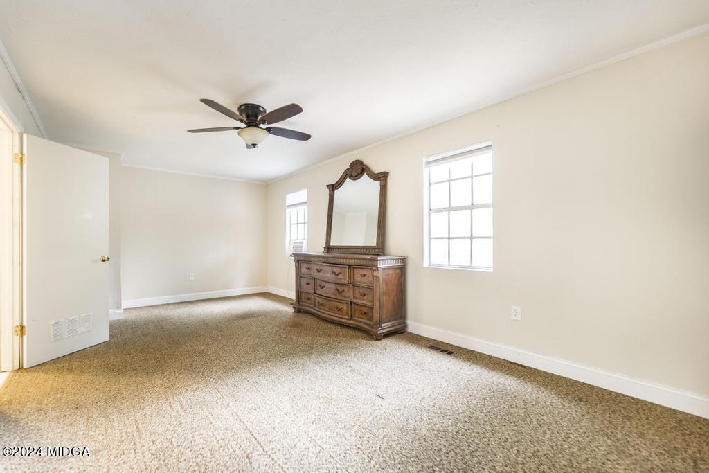 1400 Smith Chapel Road Musella, GA 31066 - Photo 12 of 28 an empty room with windows and ceiling fan