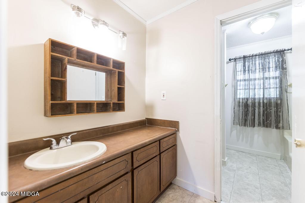 1400 Smith Chapel Road Musella, GA 31066 - Photo 14 of 28 a bathroom with a granite countertop sink and a mirror
