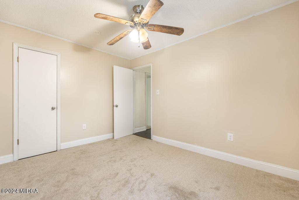 1400 Smith Chapel Road Musella, GA 31066 - Photo 18 of 28 an empty room with a ceiling fan and a window