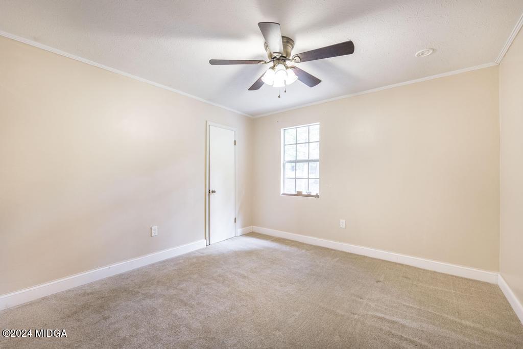 1400 Smith Chapel Road Musella, GA 31066 - Photo 21 of 28 an empty room with windows and fan