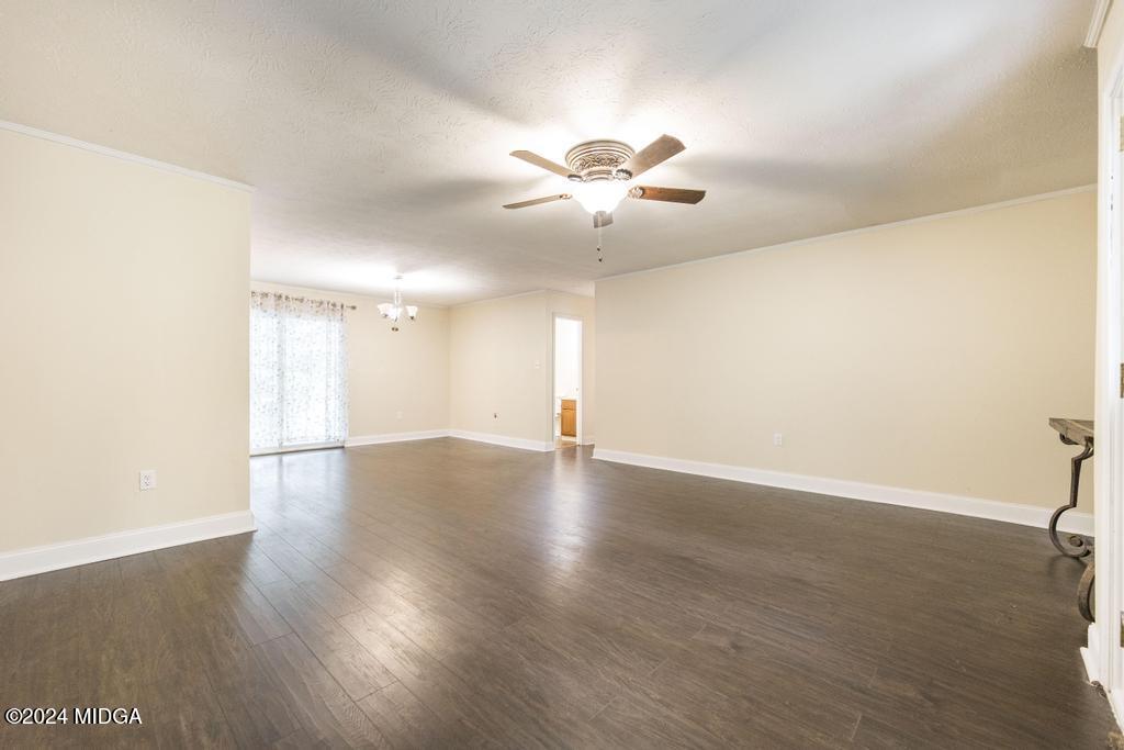 1400 Smith Chapel Road Musella, GA 31066 - Photo 3 of 28 a view of an empty room with wooden floor and a window