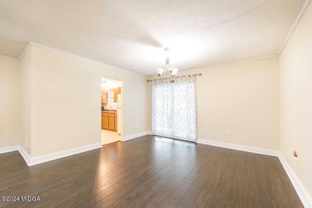 1400 Smith Chapel Road Musella, GA 31066 - Photo 7 of 28 an empty room with wooden floor and windows