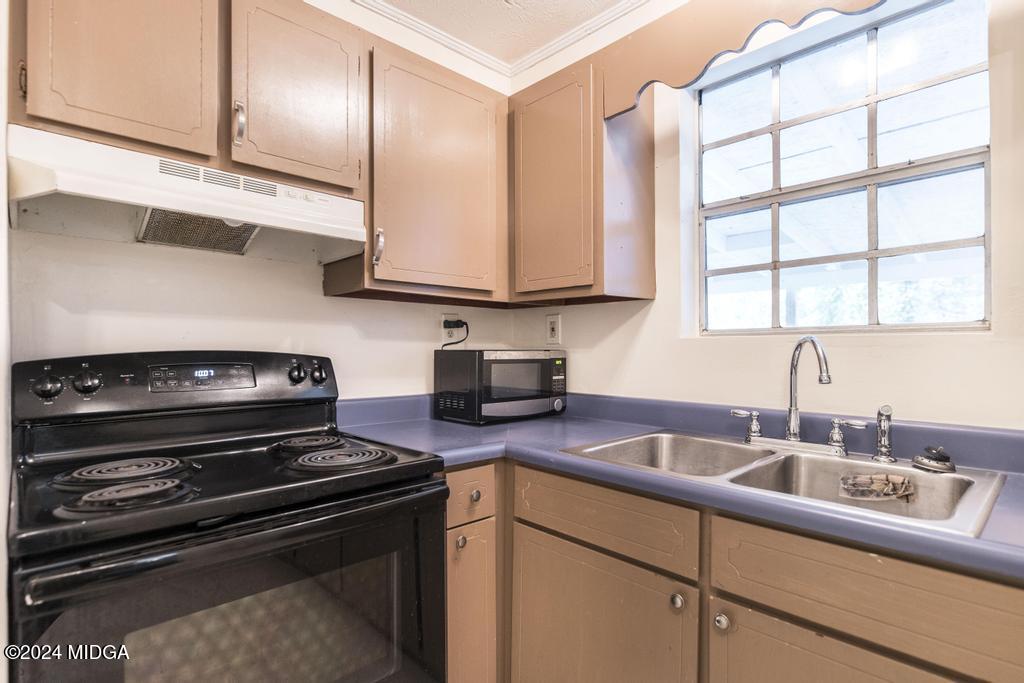 1400 Smith Chapel Road Musella, GA 31066 - Photo 10 of 28 a kitchen with stainless steel appliances granite countertop a sink stove and cabinets