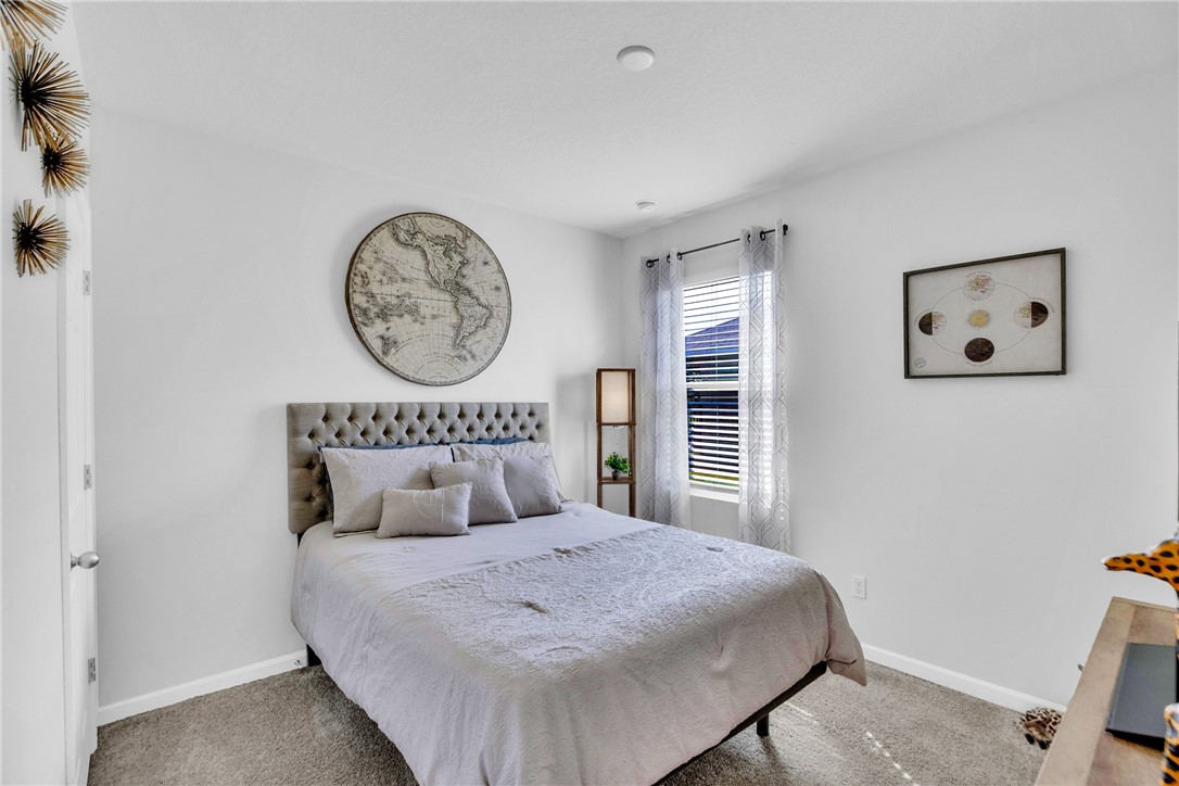 3453 Trinity Circle Fort Pierce, FL 34945 - Photo 21 of 36 a bedroom with a large bed and a window