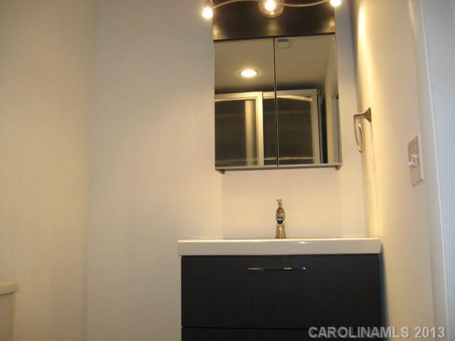 2628 B Park Road Charlotte, NC 28209 - Photo 4 of 6 a bathroom with a sink and mirror