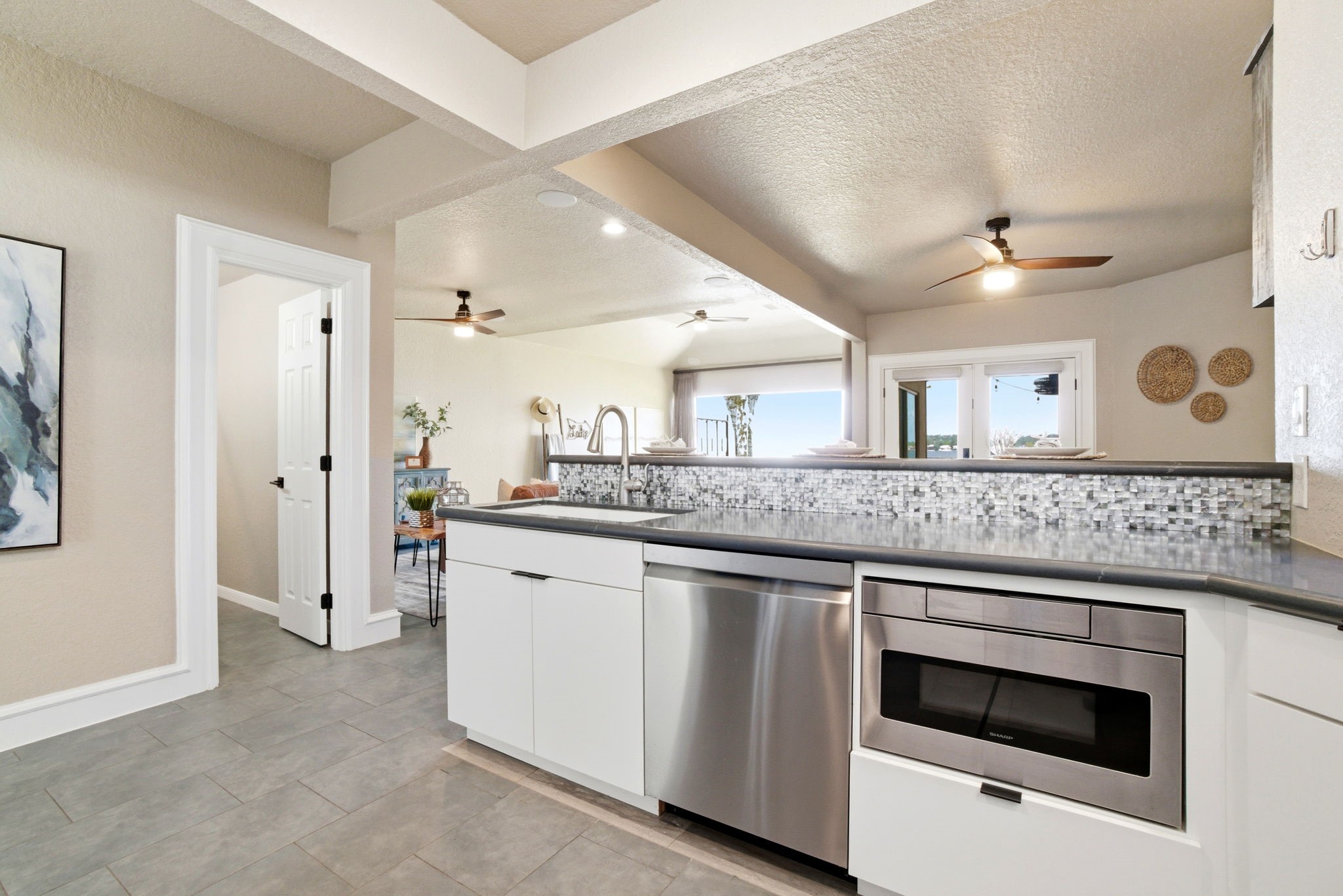 1609 Schooner Point Willis, TX 77318 - Photo 10 of 50 a kitchen with stainless steel appliances granite countertop a stove and a sink