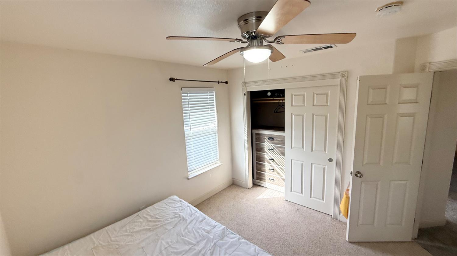 1416 San Rafael Street Los Banos, CA 93635 - Photo 18 of 21 a view of a livingroom with a ceiling fan and window