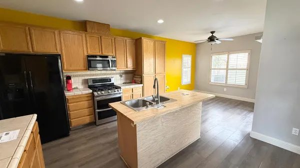 a kitchen with a sink stove and refrigerator