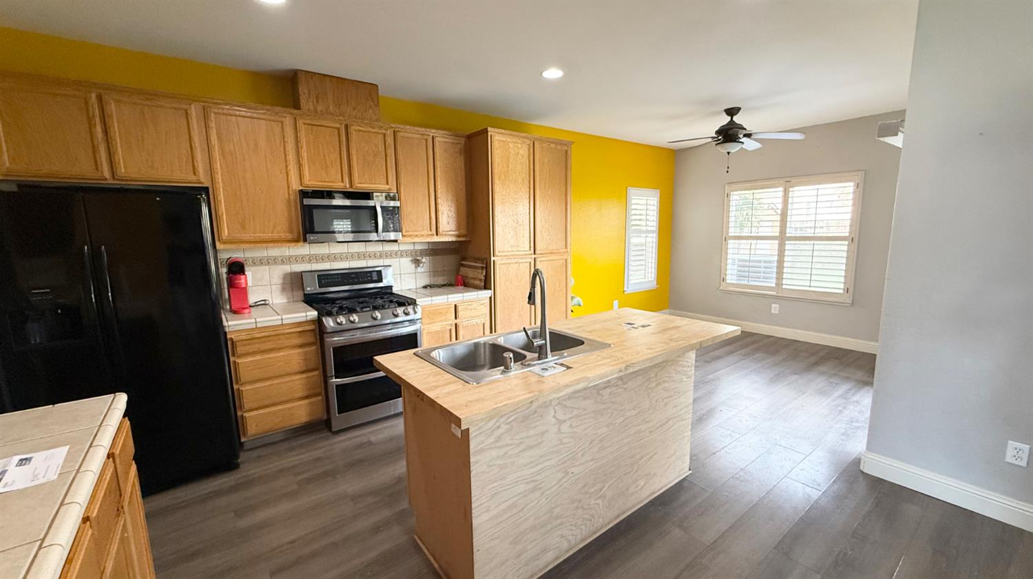1416 San Rafael Street Los Banos, CA 93635 - Photo 5 of 21 a kitchen with a sink stove and refrigerator