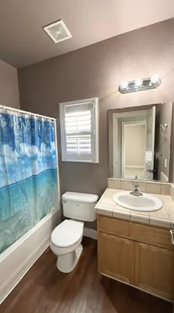 a bathroom with a toilet a sink and mirror