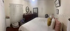 a bedroom with a bed and a chandelier