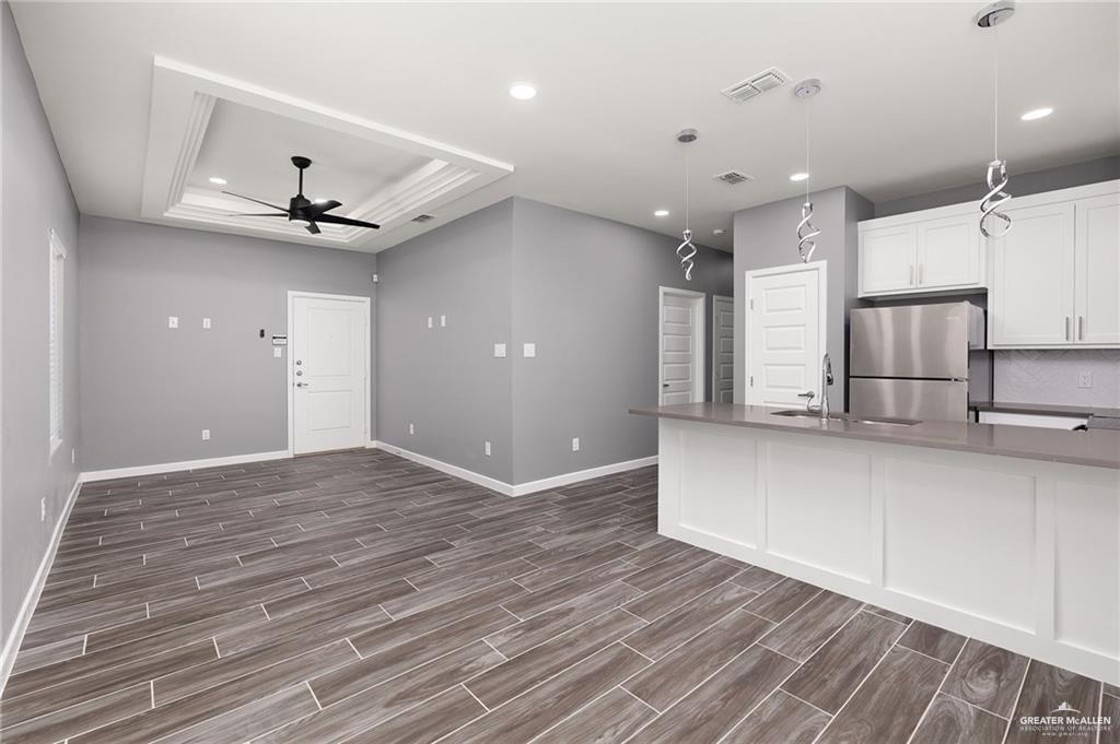 1801 Monaco Drive, Unit 4 San Juan, TX 78589 - Photo 6 of 17 an empty room with wooden floor and a ceiling fan