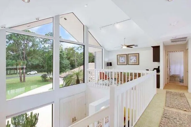 a view of a room with wooden floor and windows