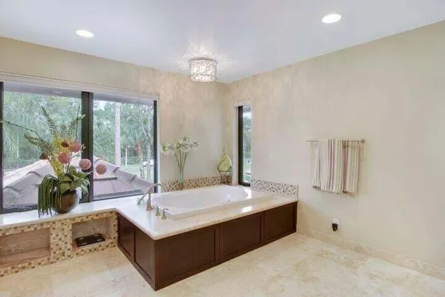 a bathroom with a double vanity sink a mirror and a bathtub