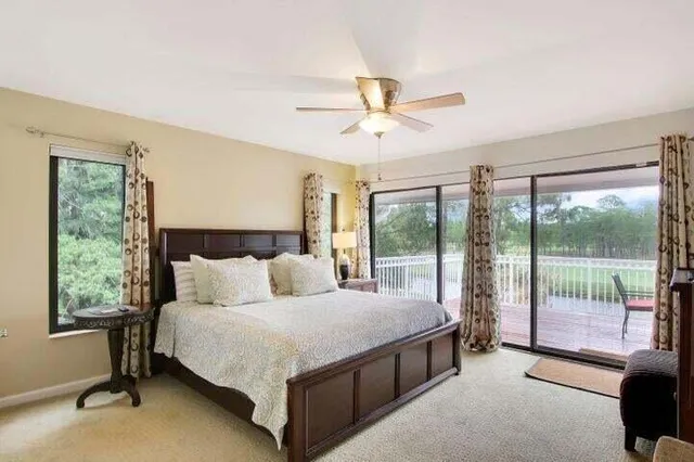 a spacious bedroom with a bed and a large window