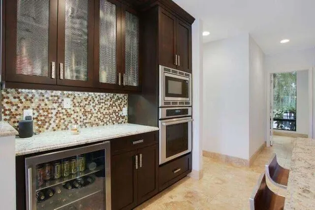 a kitchen with stainless steel appliances granite countertop a stove and a microwave
