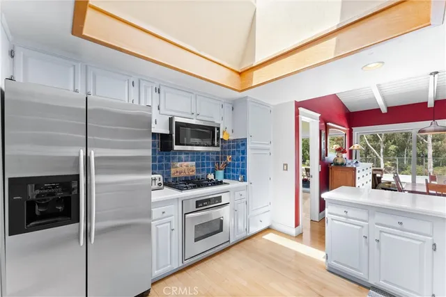 a view of a dining room with furniture large windows and wooden floor