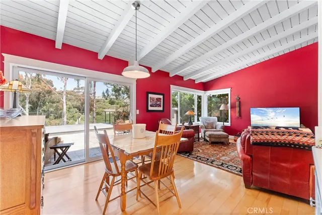 a living room with furniture a red lamp and a rug