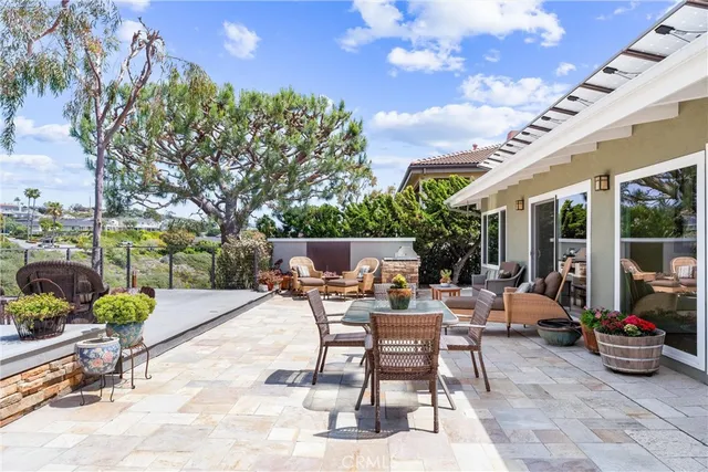 a view of a patio with dining table and chairs with a barbeque grill and couches