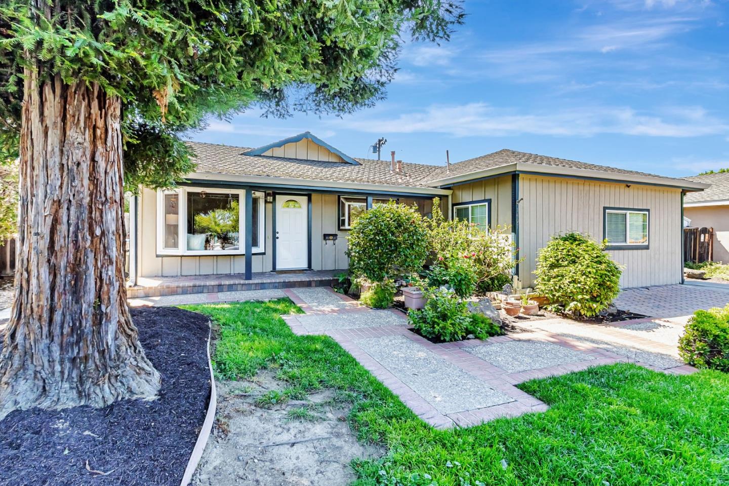 a front view of a house with garden