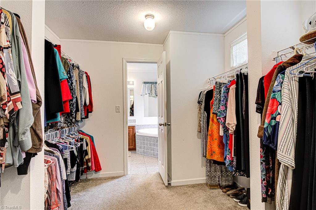 423 Brann Road Browns Summit, NC 27214 - Photo 24 of 34 Master Closet - Sits between the 2 primary bathrooms