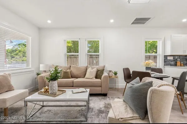 a living room with furniture and a potted plant