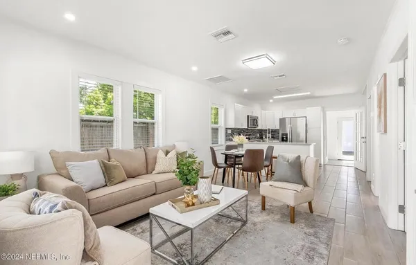 a living room with furniture and a large window