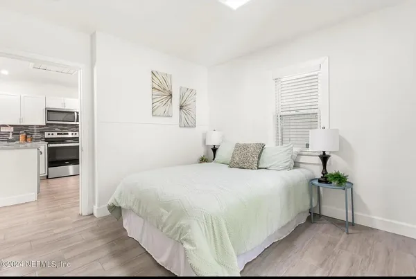a large white bed in a white room