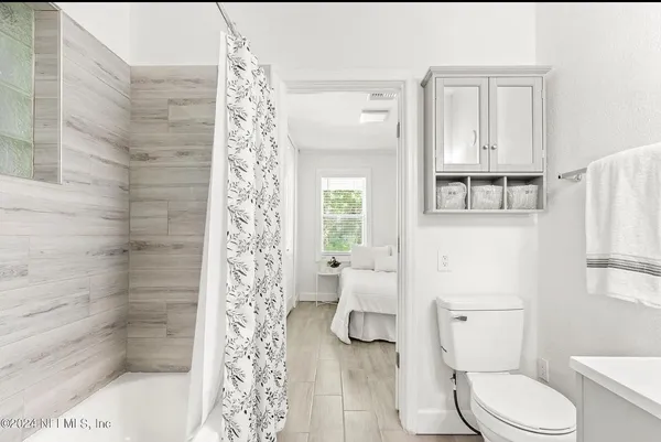 a white toilet sitting next to a bathroom sink