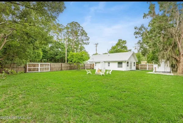 a view of a house next to a big yard
