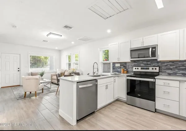 a kitchen with a sink stove and microwave