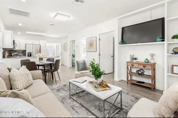 a living room with furniture and a flat screen tv
