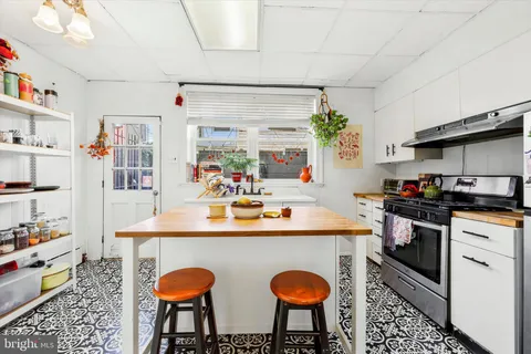 a kitchen with stainless steel appliances granite countertop a sink and a refrigerator