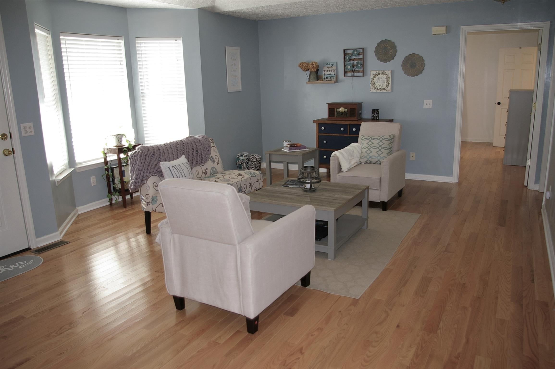 44 Old Pocahontas Road Manchester, TN 37355 - Photo 3 of 20 a living room with couches and a large mirror with wooden floor