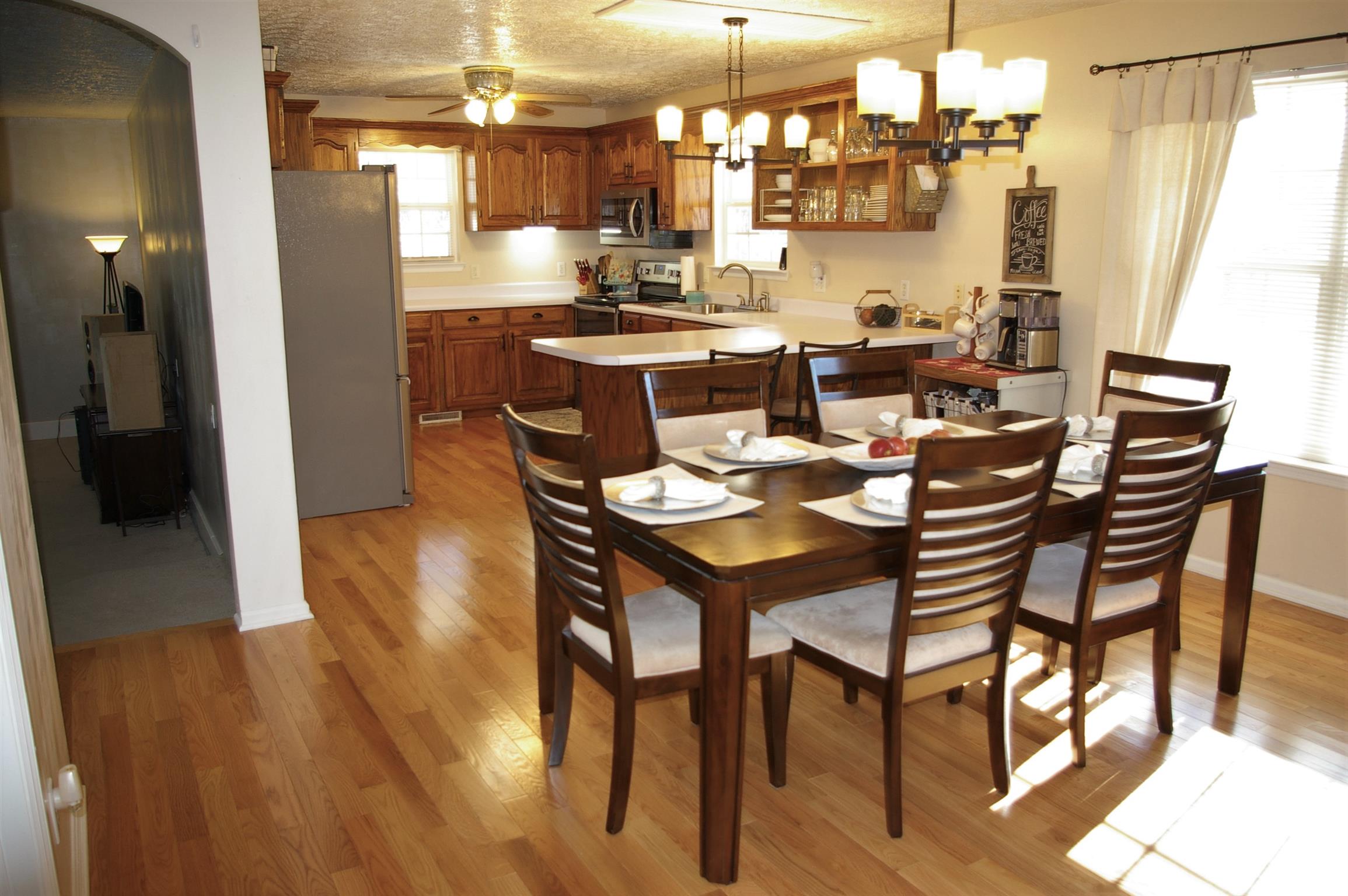 44 Old Pocahontas Road Manchester, TN 37355 - Photo 4 of 20 a dining room with stainless steel appliances kitchen island granite countertop furniture and wooden floor