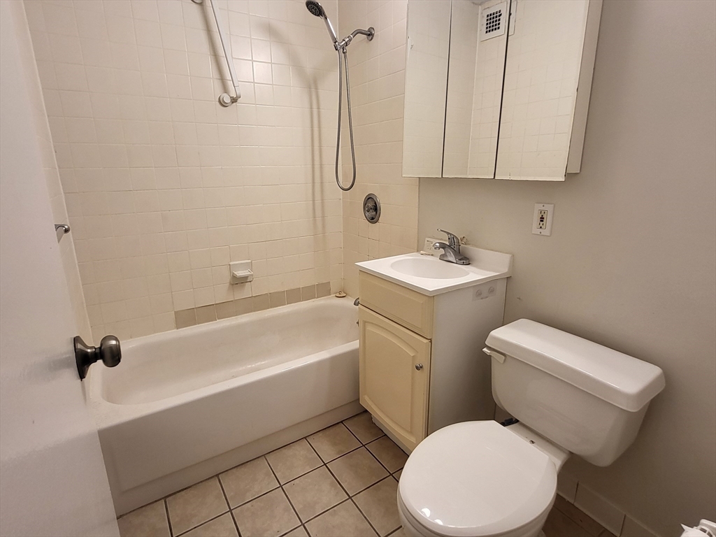 44 Washington Street, Unit 206 Brookline, MA 02445 - Photo 7 of 26 a white toilet sitting next to a bathroom sink
