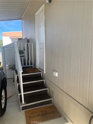 a view of a livingroom with furniture and staircase