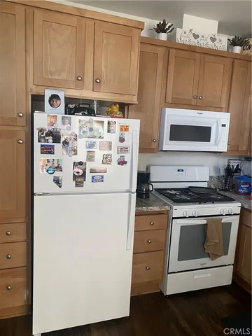 a kitchen with stainless steel appliances a stove a microwave and a refrigerator