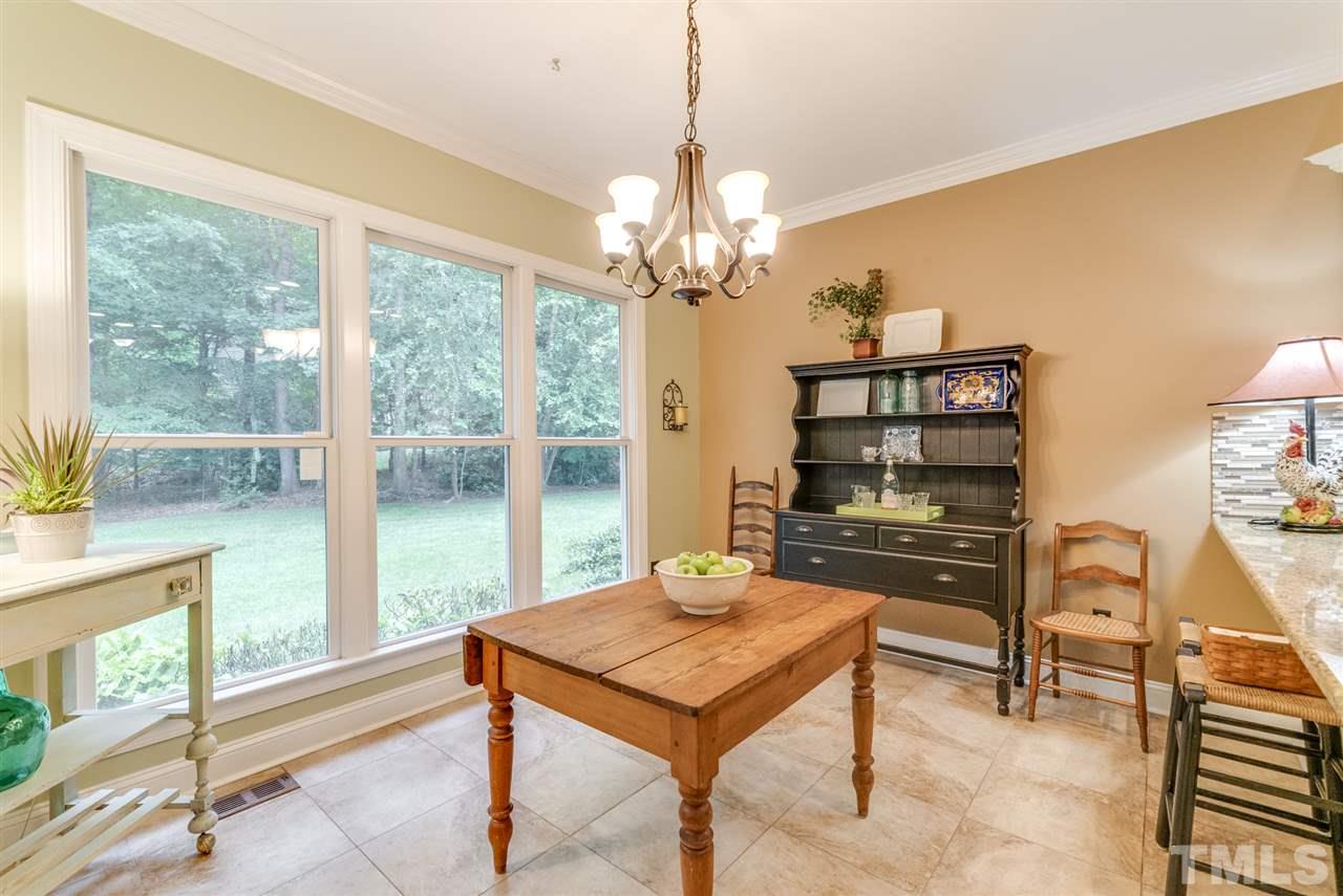 1701 Crown Glenn Place Raleigh, NC 27613 - Photo 12 of 25 a living room with furniture a table and a large window