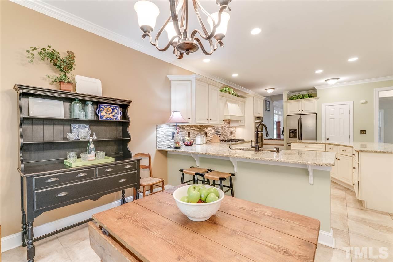 1701 Crown Glenn Place Raleigh, NC 27613 - Photo 13 of 25 a kitchen with a table and chairs