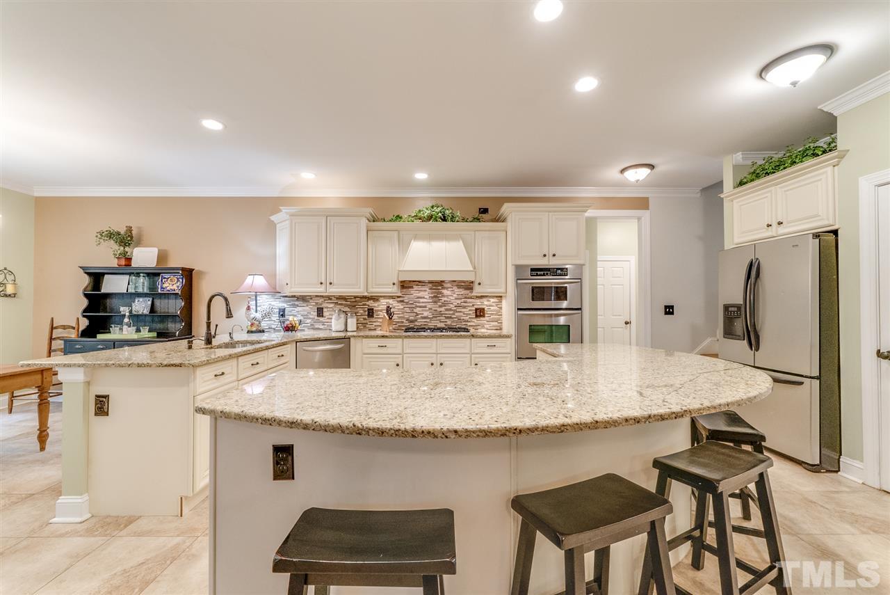 1701 Crown Glenn Place Raleigh, NC 27613 - Photo 16 of 25 a kitchen with stainless steel appliances granite countertop a sink stove and refrigerator